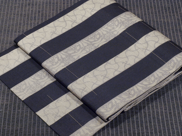 縞文様に分銅と七宝文様 絣織り 紗 名古屋帯